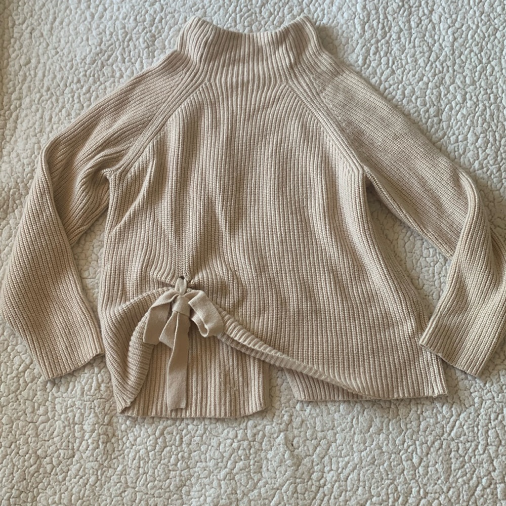 Tan/nude turtleneck sweater with little tie on the bottom, size small.